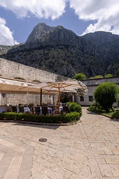 Kotor, Montenegro - June 26, 2023: View of Wood square by Old City Walls with River Gate (North Gate)