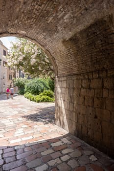 Kotor, Montenegro - June 26, 2023: View of River Gate (North Gate), entrance to Old Town and Wood square by Old City Walls