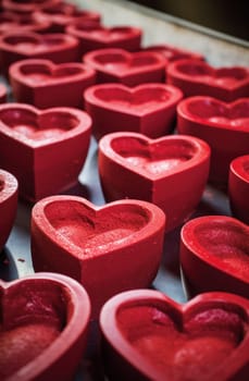 heart shaped bowls of red icing.