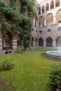 Kamieniec Zabkowicki, Poland - October 2, 2021: Kamieniec Zabkowicki Palace, 19th-century monumental palace located in a village in the Lower Silesian Voivodeship. Cloistered Courtyard  with fountain