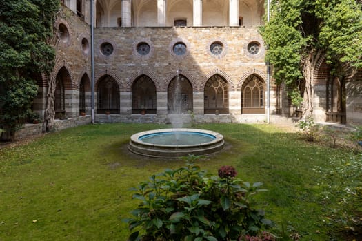 Kamieniec Zabkowicki, Poland - October 2, 2021: Kamieniec Zabkowicki Palace, 19th-century monumental palace located in a village in the Lower Silesian Voivodeship. Cloistered Courtyard  with fountain