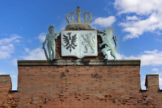 Kamieniec Zabkowicki, Poland - October 2, 2021: Facade of Kamieniec Zabkowicki Palace, 19th-century palace located in a village in the Lower Silesian Voivodeship. Coat of arms cartouche on the top