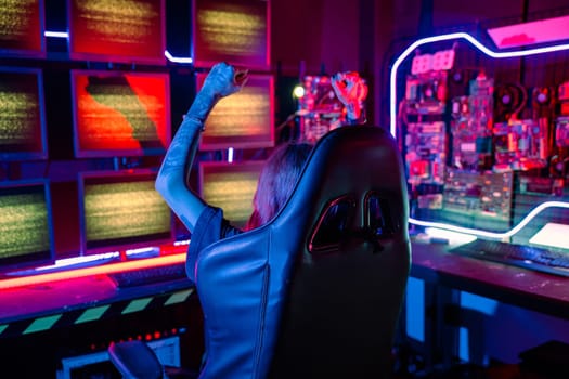 Winning. Happy Gamer young plays online video games computer she raises hands to wins tournament, young woman in gaming headphones playing video game online at home feel excited, E-Sport concept