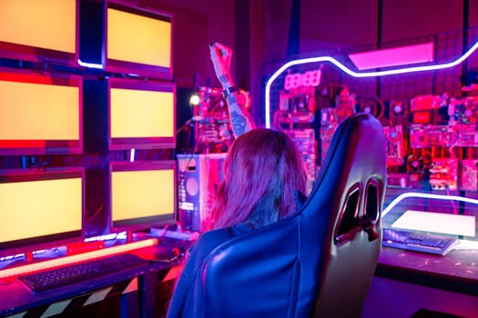 Winning. Happy Gamer young plays online video games computer she raises hands to wins tournament, young woman in gaming headphones playing video game online at home feel excited, E-Sport concept