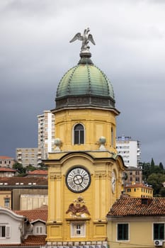Rijeka, Croatia - September 23, 2023: Medieval baroque city clock tower ( Gradska ura) by Korzo promenade, main steet in the city. The tower is located above the city gate