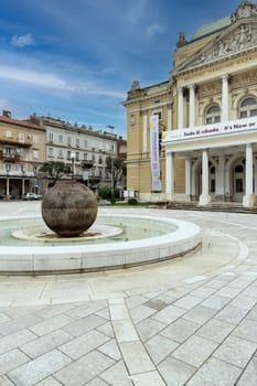 Rijeka, Croatia - September 23, 2023: Decorative building of Ivan Zajc Croatian National Theatre and Fountain of Ivan Zajc (Fontana Ivana Zajca) at classicist-art nouveau style Theatre Park