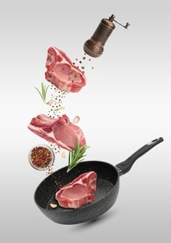 Levitating pieces of pork meat on a rib, spices. Cooking lunch
