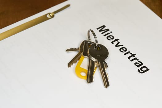 Keys and german rental contract, Mietvertrag,  for a new apartment are on a table