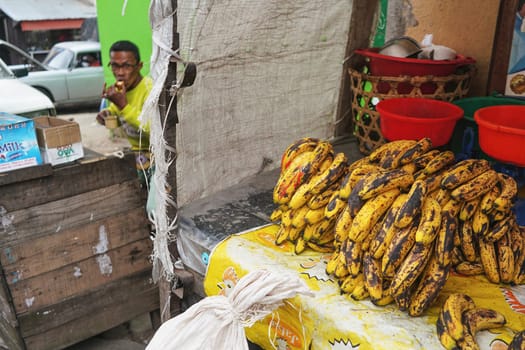 Antananarivo, Madagascar - April 24, 2019: Small ripe yellow bananas - popular fruit on Madagascar, because it's cheap - displayed at street market stall.