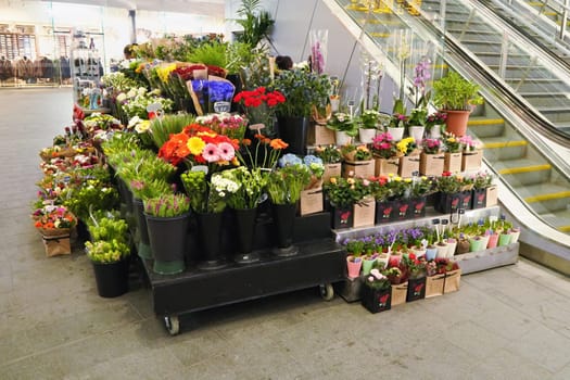 London, United Kingdom - February 01, 2019: Flowers displayed at small florist inside London Bridge underground station. Flowershops are quite common at train or tube stations in UK capital