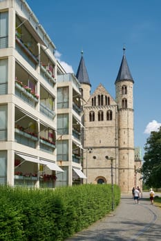 City view of Magdeburg in Germany with a residential building and the Convent of Our Lady, unser lieben Frauen, in the background