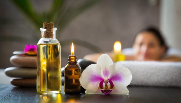 Spa still life with orchids, candles and towels on light background. AI generated