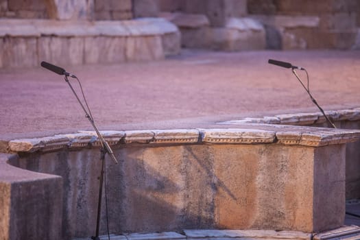 Merida, Spain - Jun 3rd, 2023: Theatre stage microphones during performance. Emerita Ludica Festival 2023.