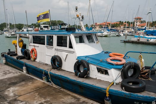 Singapore - September 4 2023: Vintage Boat Amid Modern Anchors