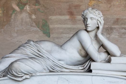 Pisa, Italy - 29 June 2023: sad statue in cemetery. Vintage white marble sculpture, woman sorrow