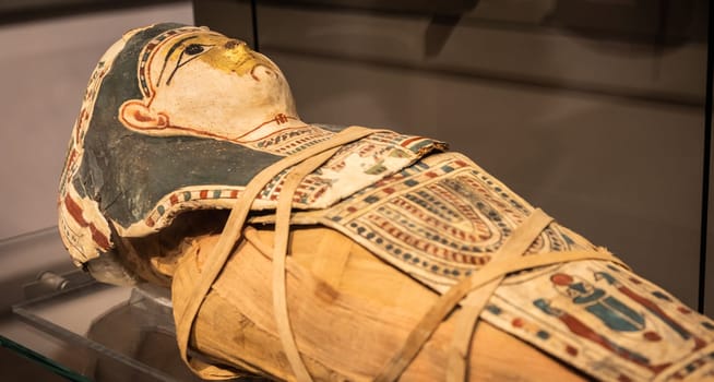 Turin, Italy - March 2023: Egyptian Museum, mummy of a baby with a mask - 2nd Century BC
