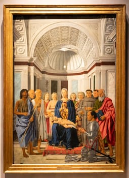 Milan, Italy - 23 September 2023: Brera antique painting museum. Madonna and child with saints, angels and Federico da Montefeltro, by painter Piero della Francesca, 1470
