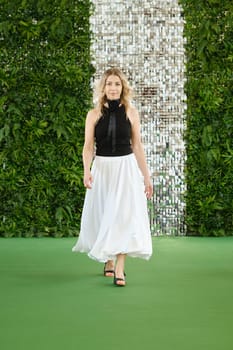 Senior woman walking stylishly in fashion clothing.