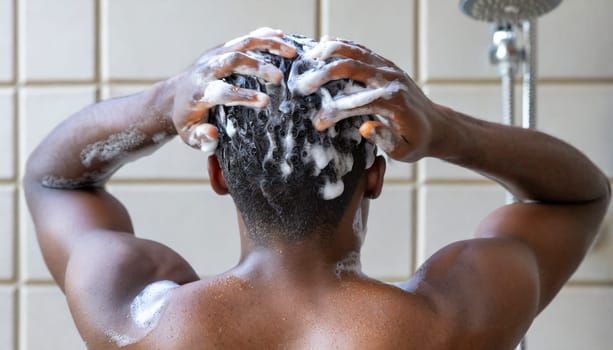 Man washing his hair in the shower, close-up, rear view. AI generated