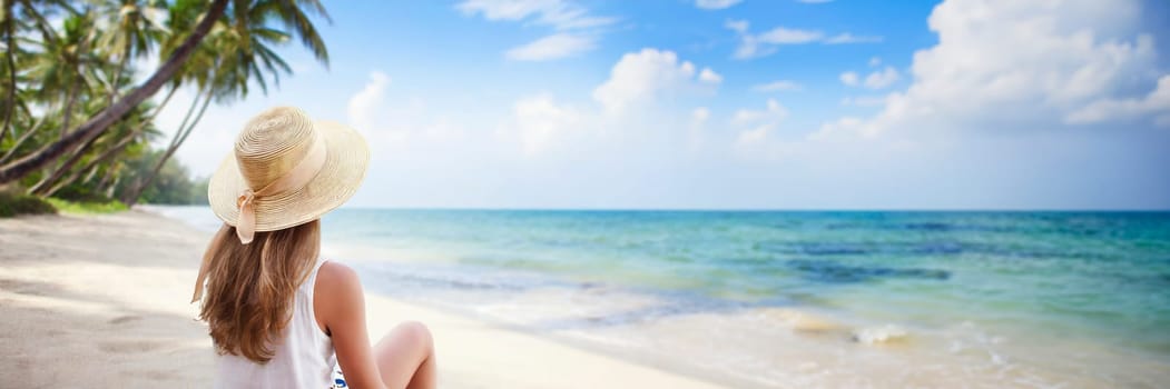 Young woman in dress and hat on sunny tropical beach. panoramic banner with copy space. AI generated