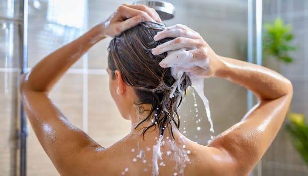 Woman washing his hair in the shower, close-up, rear view. AI generated