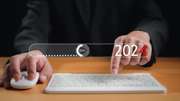 Businessman touch on virtual bar status to change to 2024, countdown of merry Christmas and happy new year by technology concept, start new business and new life. New year's start-up.