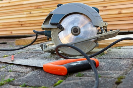 A carpenter's circular saw near a pile of boards