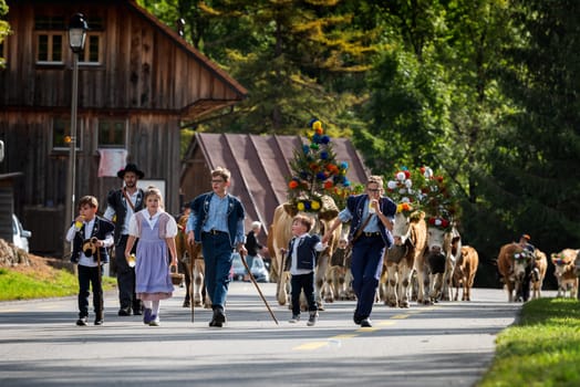Charmey, Fribourg, Switzerland - 28 September 2019 : Farmers with a herd of cows on the annual transhumance at Charmey near Gruyeres, Fribourg zone on the Swiss alps