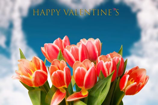 Happy Valentines Day greeting card. Decorative bouquet of tulips over blurred blue sky in shape of a heart. Concept of holidays, postcard, Mothers Day, Banner and 8 March. Space.