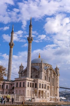 Istanbul, Turkey - November 11, 2023. Ortakoy mosque situated at the waterside of the pier. View of the Bosphorus Strait. Besiktas district, city of Istanbul, Turkey.