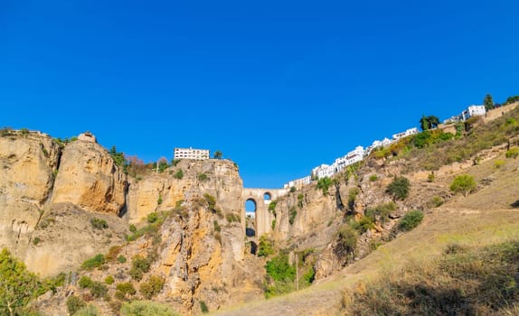 Famous view on the Puente Nuevo crossing the El Tajo Canyon in Ronda, historical city in Andalusia, Spain