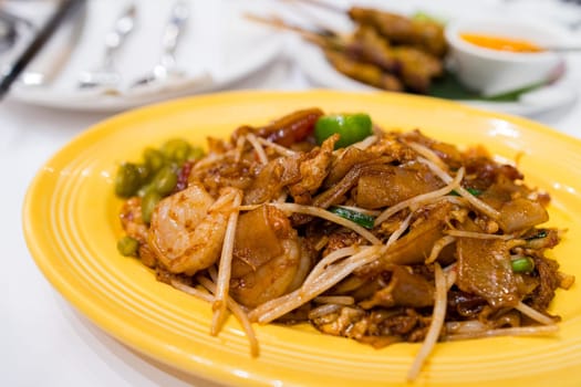 Pan fried flat noodles dish in Thai restaurant
