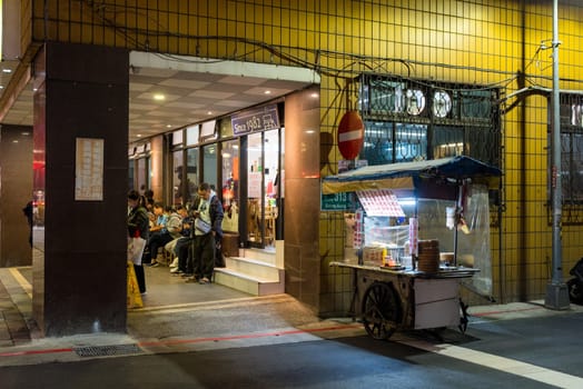 Taipei, Taiwan 26 November 2023: Vendor food stall in the street in Taipei city at night