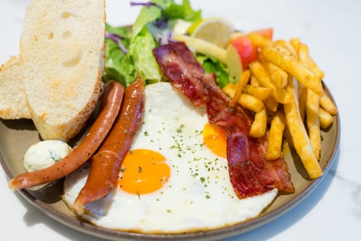 All day breakfast dish with fries and bacon