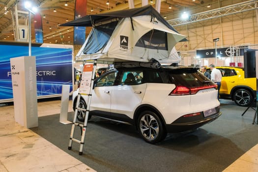 Lisbon, Portugal - May 12, 2023: Aiways U5 Prime electric car with car tent on roof on display at ECAR SHOW - Hybrid and Electric Motor Show