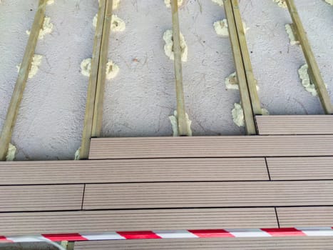 Installation of wooden flooring on a polyurethane foam base. Urban background close to public park