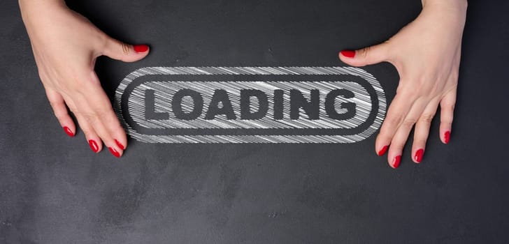Loading form and two female hands on a black background, waiting for the start