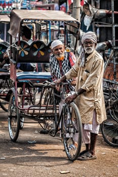 AGRA, INDIA - NOVEMBER 21, 2012: Bicycle rickshaws in the street of Agra, Uttrar Pradesh, India