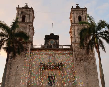 The facade of the San Servacio Church, Templo de San Servacio, colorfully decorated and surrounded by palmtrees, Valladolid, Mexico 2022
