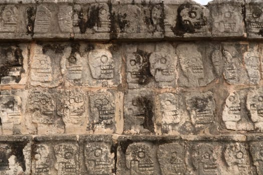 Skull pattern on the Tzompantli, skull platform, plataforma de los craneos, at Chichen Itza, close to Valladolid, Mexico 2022