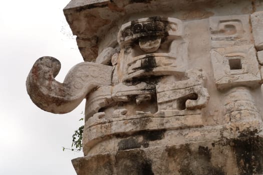 Typical mayan mask face on the edge of the facade of The Church, La Iglesia at Chichen Itza, close to Valladolid, Mexico 2022