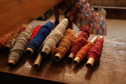 Colorful threads at a traditional carpet weaving workshop, Oaxaca, Mexico 2022