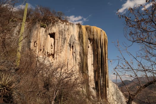 View from the side onto the large petrified waterfall at Hierve El Agua on the way down, Oaxaca, Mexico 2022
