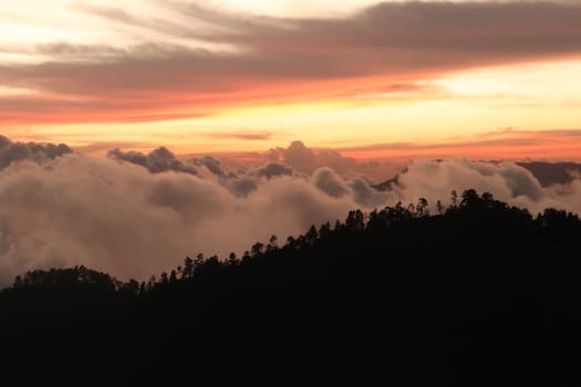 The landscape around San Jose del Pacifico at sunset, clouds, hills and a colorful sky, Oaxaca, Mexico 2022