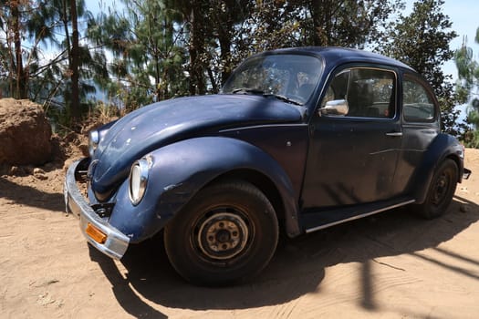 Old car parked on a sandy road leading from San Jose del Pacifico to San Mateo Rio Hondo, Oaxaca, Mexico 2022