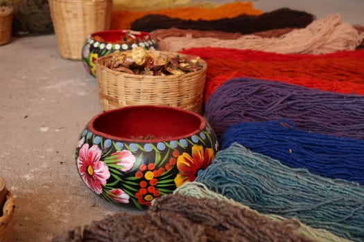 Natural ingredients needed to dye the threads for a traditional mexican carpet, displayed at a traditional workshop, Oaxaca, Mexico 2022