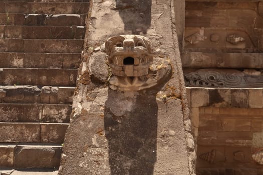Closer look on one of the snake heads attached next to the stairs of the Temple of the Feathered Serpent/Templo de Quetzalcóatl, Mexico City 2022