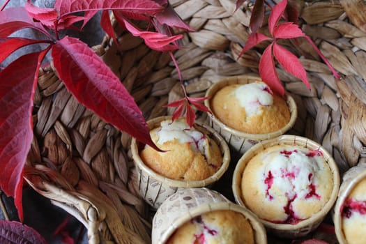 Homemade cupcakes with cherry filling decorated with autumn leaves