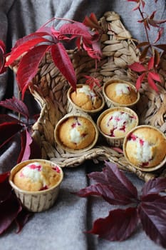 Homemade cupcakes with cherry filling decorated with autumn leaves .Texture or background