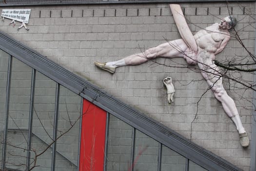 Berlin,Germany 1. April 2018: The relief sculpture Friede sei mit Dir, also known as the cock of Berlin is an artwork by sculptor Peter Lenk. It is located in Berlin at the building of the editorial staff of German newspaper taz